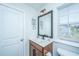 Well-lit bathroom with a wood vanity, sink, and a modern mirror at 101 Firebrick Way, Summerville, SC 29483