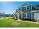 Inviting two-story home featuring a pristine lawn and charming front porch at 101 Firebrick Way, Summerville, SC 29483