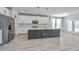 Modern kitchen featuring stainless steel appliances, a large island with seating, and bright white cabinetry at 101 Firebrick Way, Summerville, SC 29483