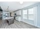 Stylish kitchen featuring white cabinets, stainless steel appliances, an island, and hardwood floors at 101 Firebrick Way, Summerville, SC 29483