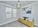 Cozy living room featuring a bright yellow sofa, large art piece, and a contemporary chandelier at 101 Firebrick Way, Summerville, SC 29483