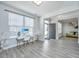 Bright living room with wood floors, white walls, and a desk area with a view of the front door at 101 Firebrick Way, Summerville, SC 29483