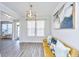 Comfortable living area with a yellow sofa, large window, and modern light fixture creating a warm ambiance at 101 Firebrick Way, Summerville, SC 29483