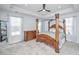 Elegant bedroom with a four-poster bed, tray ceiling, and ample natural light from the large windows at 101 Firebrick Way, Summerville, SC 29483