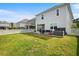 Backyard view with patio, gas fire pit, and partial privacy fence at 1052 Sago Palm Ct, Mount Pleasant, SC 29429