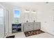 Bright bathroom with double vanity, tiled shower, and window with neighborhood view at 1052 Sago Palm Ct, Mount Pleasant, SC 29429