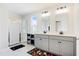 Bright bathroom with double vanity, tiled shower, and window with neighborhood view at 1052 Sago Palm Ct, Mount Pleasant, SC 29429
