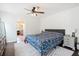Bright bedroom featuring ceiling fan, patterned bedding, and an en-suite bathroom for added convenience at 1052 Sago Palm Ct, Mount Pleasant, SC 29429