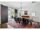 Dining room with sliding doors, chandelier, long wooden table, and an area rug at 1052 Sago Palm Ct, Mount Pleasant, SC 29429
