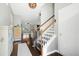 Inviting foyer showcasing hardwood floors, a staircase with modern railings, and an open view to the living area at 1052 Sago Palm Ct, Mount Pleasant, SC 29429