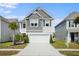 Traditional two-story home with a two-car garage, manicured lawn, and neat landscaping enhancing curb appeal at 1052 Sago Palm Ct, Mount Pleasant, SC 29429