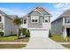 Charming two-story home featuring a grey shingled roof, attached two-car garage, and a well-manicured front lawn at 1052 Sago Palm Ct, Mount Pleasant, SC 29429