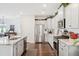 Modern kitchen features white cabinets, stainless steel appliances, and granite countertops at 1052 Sago Palm Ct, Mount Pleasant, SC 29429