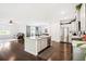 Open-concept kitchen boasts a large island, stainless steel appliances, and dark hardwood floors at 1052 Sago Palm Ct, Mount Pleasant, SC 29429