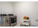 Well-equipped laundry room with modern, stainless steel washer and dryer, plus practical storage solutions at 1052 Sago Palm Ct, Mount Pleasant, SC 29429