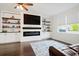 Comfortable living room features a modern fireplace, built-in shelves, and hardwood floors, creating a cozy ambiance at 1052 Sago Palm Ct, Mount Pleasant, SC 29429
