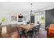 Open-concept living and dining area with hardwood floors, stylish chandelier, and sliding doors to the backyard at 1052 Sago Palm Ct, Mount Pleasant, SC 29429