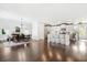 Spacious open-concept living space featuring hardwood floors, a kitchen island, dining area, and ample natural light at 1052 Sago Palm Ct, Mount Pleasant, SC 29429