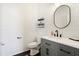 Chic powder room featuring shiplap walls, modern fixtures, and a gray vanity with a sleek countertop at 1052 Sago Palm Ct, Mount Pleasant, SC 29429