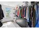 Spacious walk-in closet with custom shelving, ample storage, a window for natural light and organization at 1052 Sago Palm Ct, Mount Pleasant, SC 29429