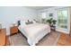 Bright bedroom with hardwood floors, neutral tones, and two windows offering natural light at 1070 Blue Marlin Dr, Charleston, SC 29412