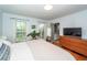 Spacious bedroom with natural light, hardwood floors, and ensuite bathroom entrance at 1070 Blue Marlin Dr, Charleston, SC 29412
