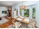Bright dining room with hardwood floors, large windows, and a decorative light fixture at 1070 Blue Marlin Dr, Charleston, SC 29412