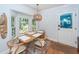 Dining area features a wooden table set, bay windows, and modern light fixture at 1070 Blue Marlin Dr, Charleston, SC 29412