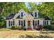 Charming home featuring dormer windows, a brick walkway, and mature landscaping at 1070 Blue Marlin Dr, Charleston, SC 29412
