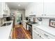 Bright galley kitchen with stainless appliances, quartz countertops, and white cabinetry at 1070 Blue Marlin Dr, Charleston, SC 29412