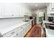Well-lit kitchen with white cabinets, quartz countertops, and hardwood floors at 1070 Blue Marlin Dr, Charleston, SC 29412