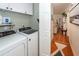 Functional laundry room with white washer and dryer units and overhead cabinets at 1070 Blue Marlin Dr, Charleston, SC 29412