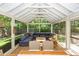 Screened-in porch boasting a large sectional sofa, coffee table, and outdoor seating at 1070 Blue Marlin Dr, Charleston, SC 29412