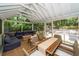 Large screened porch with dining and lounge areas offering a seamless transition to the outdoors at 1070 Blue Marlin Dr, Charleston, SC 29412