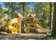 Backyard with a wooden playset featuring slides, climbing structures, and charming details for outdoor adventures at 112 Huckleberry Ln, Summerville, SC 29485