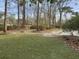 Expansive backyard with lush green grass, mature trees, and a playset, perfect for outdoor activities and relaxation at 112 Huckleberry Ln, Summerville, SC 29485