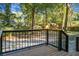 Inviting backyard featuring a raised deck, lush greenery, mature trees, and a playset for outdoor fun at 112 Huckleberry Ln, Summerville, SC 29485