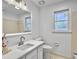Well-lit bathroom with a modern vanity, quartz countertop, decorative mirror, and a neutral color palette at 112 Huckleberry Ln, Summerville, SC 29485