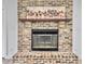 Close-up of fireplace featuring an attractive brick surround, mantel, and gas insert at 112 Huckleberry Ln, Summerville, SC 29485