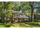 Beautifully landscaped two-story brick home with lush green trees surrounding the property at 112 Huckleberry Ln, Summerville, SC 29485