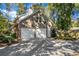 Detached two-car garage with white doors and brick exterior, surrounded by trees at 112 Huckleberry Ln, Summerville, SC 29485