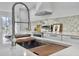 Bright kitchen with stainless steel faucet, range hood, stylish backsplash and light countertops at 112 Huckleberry Ln, Summerville, SC 29485