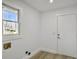 Bright, minimalist laundry room with modern flooring, a window, and essential hookups for appliances at 112 Huckleberry Ln, Summerville, SC 29485