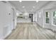 Open-concept area featuring kitchen, dining, and living spaces with hardwood floors and natural light at 112 Huckleberry Ln, Summerville, SC 29485