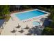 A pristine swimming pool, surrounded by chairs and umbrellas, offers a luxurious place to relax at 112 Huckleberry Ln, Summerville, SC 29485