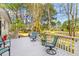 Relaxing back deck with chairs and a view of the green grass lawn at 1164 Out Of Bounds Dr, Summerville, SC 29485
