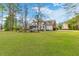 Large green backyard with trees and a view of the house at 1164 Out Of Bounds Dr, Summerville, SC 29485