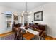Bright dining room with a wood table, buffet, and elegant chandelier at 1164 Out Of Bounds Dr, Summerville, SC 29485