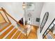 Bright foyer features hardwood floors, grand staircase, and natural light from large window at 1164 Out Of Bounds Dr, Summerville, SC 29485