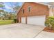 A spacious three-car garage with ample parking space and a red brick exterior is on display at 1164 Out Of Bounds Dr, Summerville, SC 29485